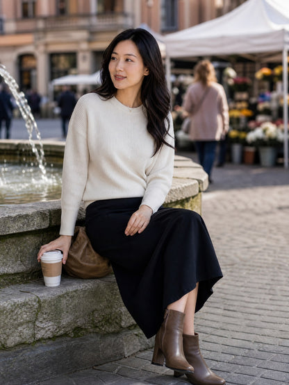 Elite Journey worn discreetly beneath a fine-rib sweater and midi skirt